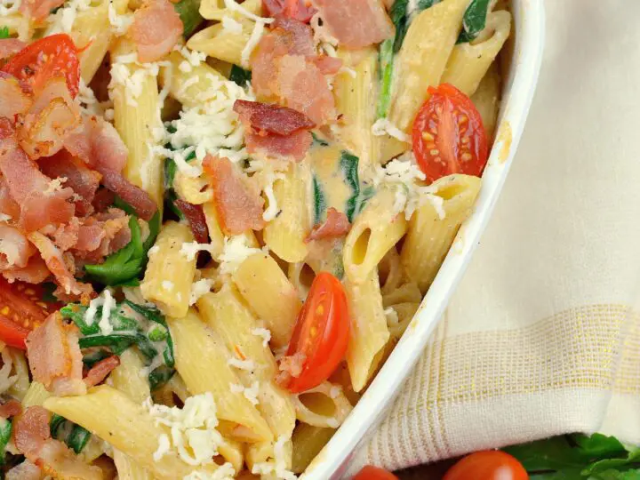 Cheesy Bacon and Spinach Penne Pasta in Pan. Treat your family this holiday season with a deliciously easy to make Cheesy Bacon and Spinach Penne Pasta. Perfect for any dinner time during the year. Shared via Jays Sweet N Sour Life.