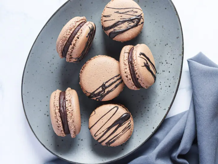 Chocolate Macarons with Salted Caramel Filling Plated.These Chocolate Macarons with Salted Caramel Filling are a delight, so soft and full of flavor. Perfect for entertaining as well as sweet treat gifts to loved ones during the holidays.&nbsp;