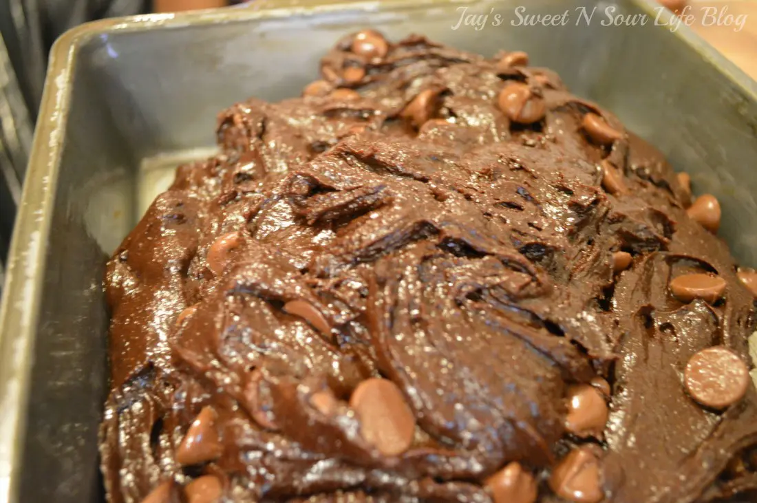 fudgy brownie cheesecake in pan. Decadent made from scratch fudgy brownies smothered with a creamy cheesecake filling. These easy to make fudgy cheesecake brownies are moist and full of decadent chocolate flavor.