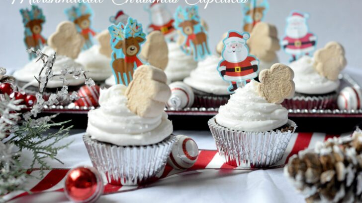 A quick and easy holiday dessert recipe, these Marshmallow Christmas Cupcakes are made with boxed cake mix for a hassle-free cupcake recipe. Top these moist chocolate cupcakes with marshmallow frosting and fun holiday-themed candy.