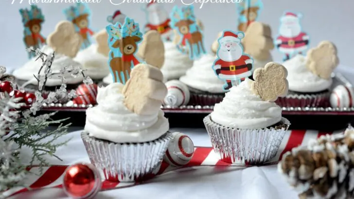 A quick and easy holiday dessert recipe, these Marshmallow Christmas Cupcakes are made with boxed cake mix for a hassle-free cupcake recipe. Top these moist chocolate cupcakes with marshmallow frosting and fun holiday-themed candy.