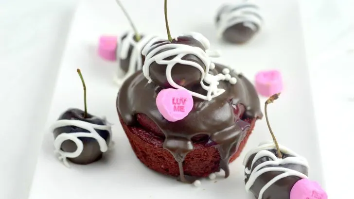 Cherry Valentines Day Cupcake Closeup.A Red Velvet Cupcake filled with a delicious from scratch Cherry Sauce. Topped with Chocolate Ganache and chocolate dipped cherries.