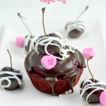 Cherry Valentines Day Cupcakes. A Red Velvet Cupcake filled with a delicious from scratch Cherry Sauce. Topped with Chocolate Ganache and chocolate dipped cherries.