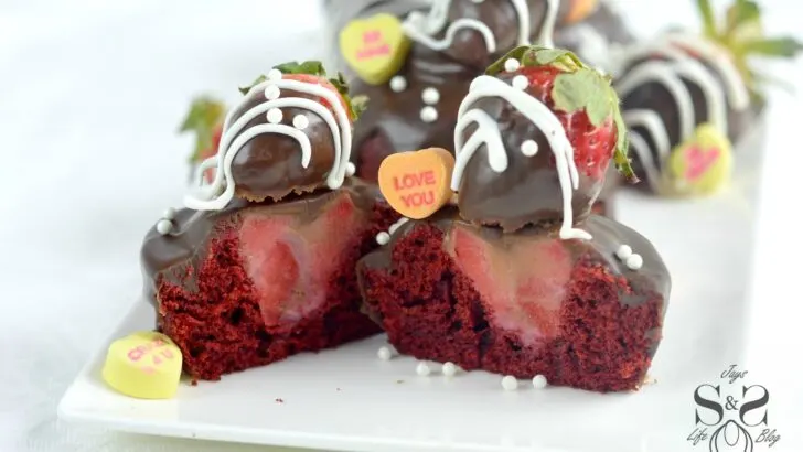 Strawberry Valentines Day Cupcakes hero 1.1. Make these deliciously moist Red Velvet Cupcakes stuffed with Strawberries. Topped with Chocolate Ganache and chocolate dipped strawberries.