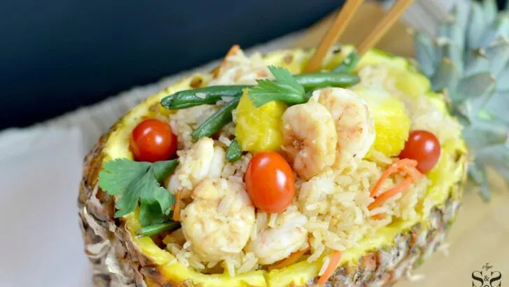 A homemade Pineapple Fried Rice featuring freshly made steamed rice with pineapple juice, fresh vegetables, pineapple chunks, and tiger shrimp. This easy pineapple fried rice recipe is served in a sweet and savory fried rice dish that is better than takeout.