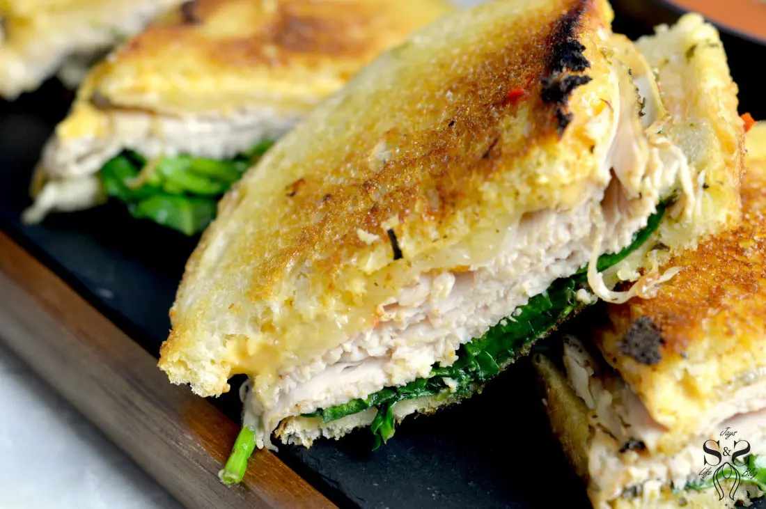 Turkey Pesto Grilled Cheese Sandwic closeup. If you are looking for that restaurant&nbsp;quality bistro sandwich, look no further. Bring the bistro home when you try my Turkey Pesto Grilled Cheese. 