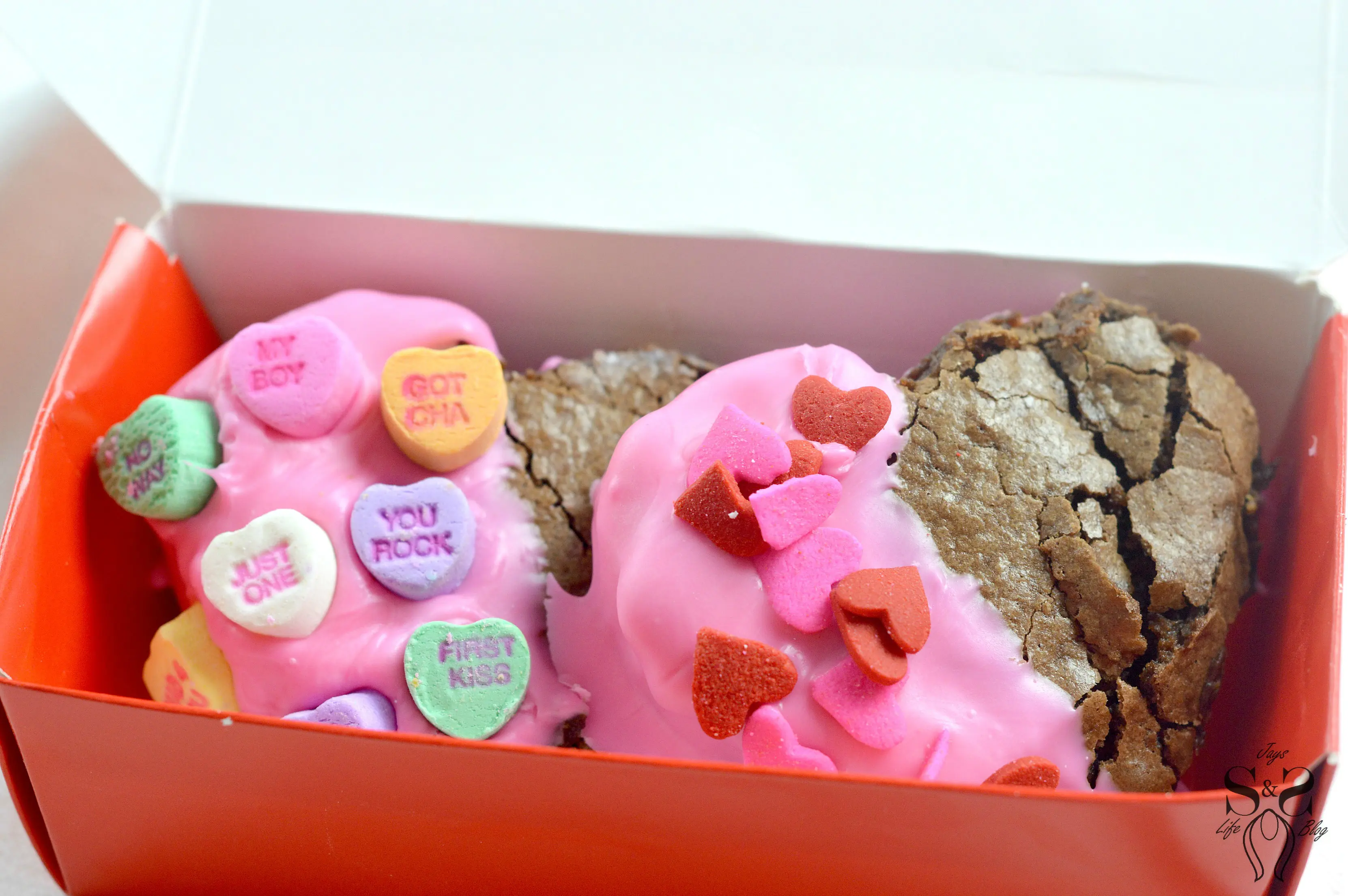 Valentine's Day Fudgy Brownies inside box. A from-scratch Valentine's Day Fudgy Brownie recipe, stuffed with butterscotch chips. Dipped in chocolate and then topped with candy hearts and sprinkles.