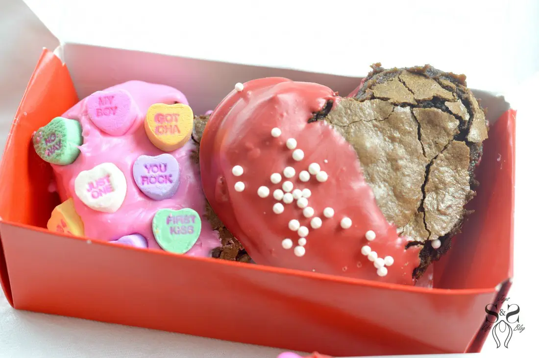 Valentine's Day Fudgy Brownies in box. A from-scratch Valentine's Day Fudgy Brownie recipe, stuffed with butterscotch chips. Dipped in chocolate and then topped with candy hearts and sprinkles.
