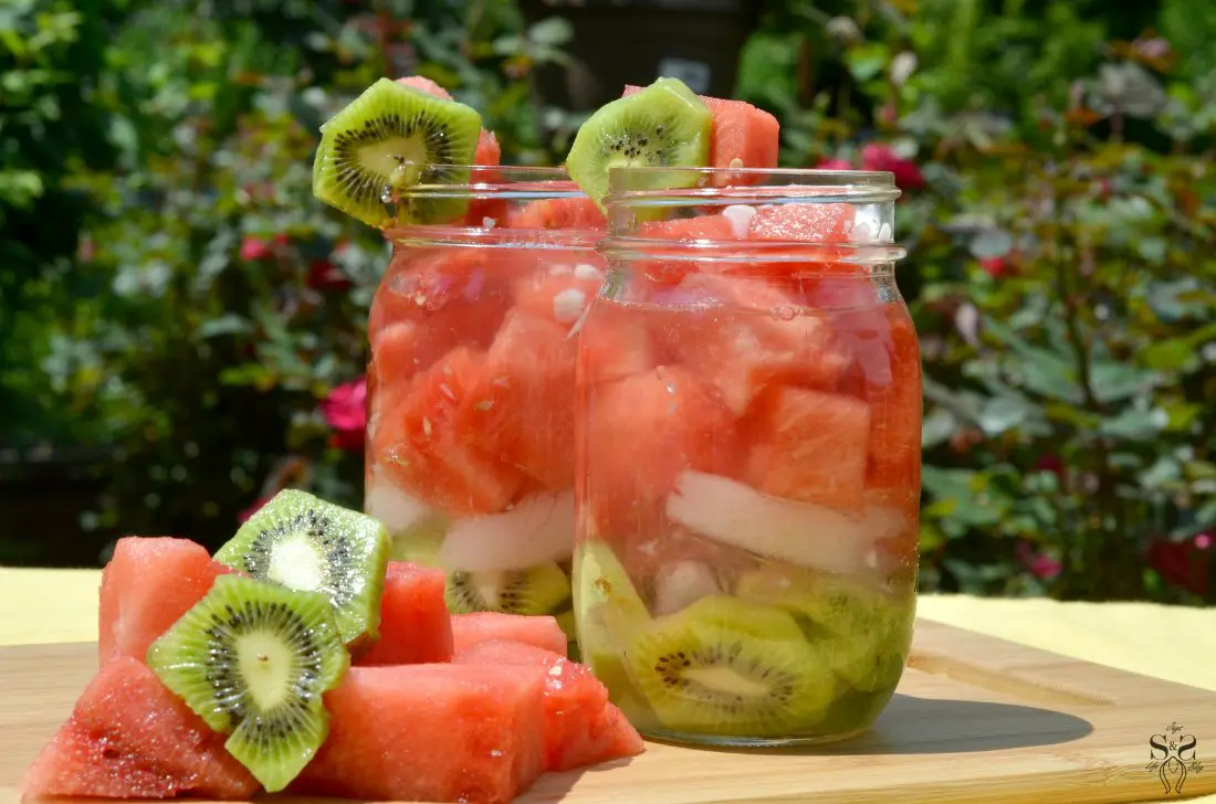 Watermelon Kiwi Infused Water On Table. A refreshing recipe for Watermelon Kiwi Infused Water will keep you hydrated and full, it's perfect for picnics and backyard BBQ's.