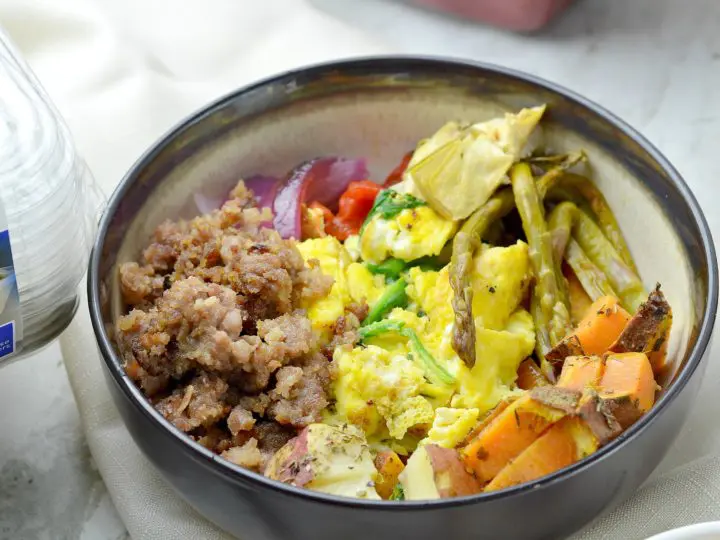 Easy To-Go Brunch Bowl filled with maple sausage, roasted vegetables, and potatoes. This delicious savory breakfast bowl recipe is perfect for on-the-go families and makes for a great base for other breakfast bowl ideas.