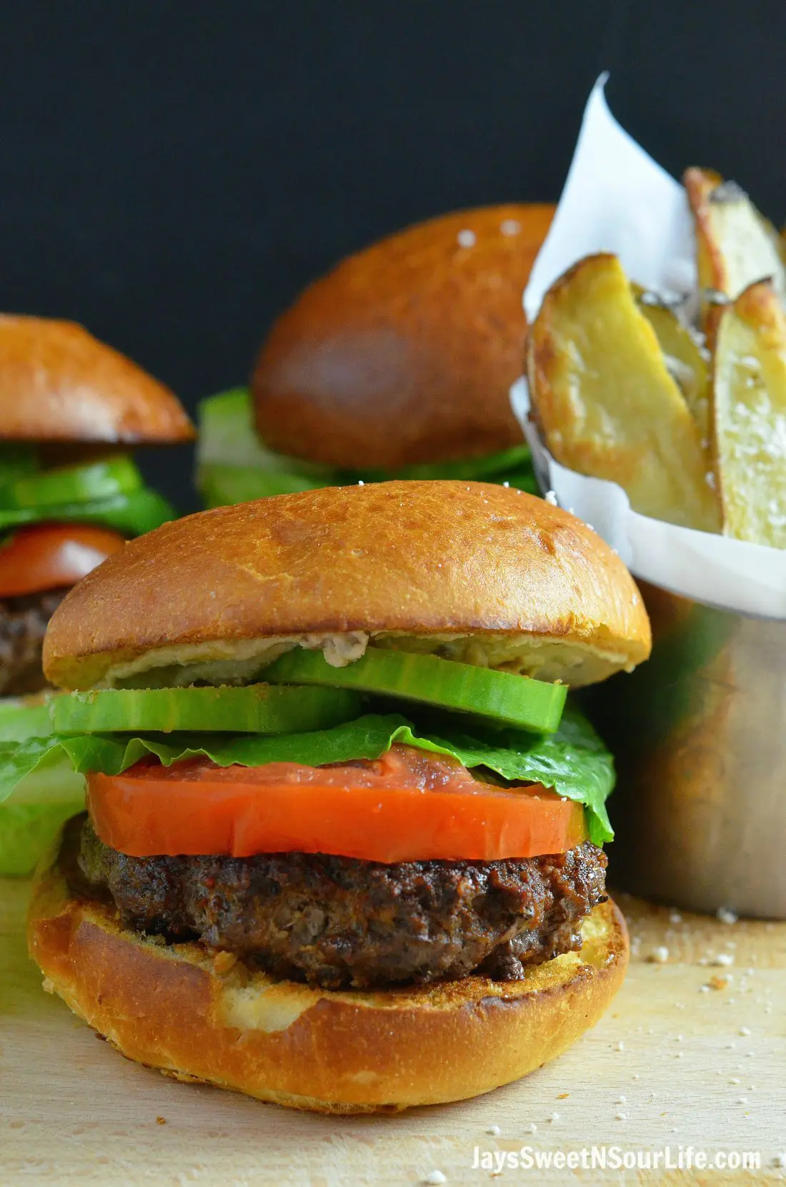 Mediterranean Bison Burger and Fries Closeup. Deck the halls and your home with the smell of delicious fresh made Mediterranean Bison Burger and fries using Boar's Hummus as a spread.