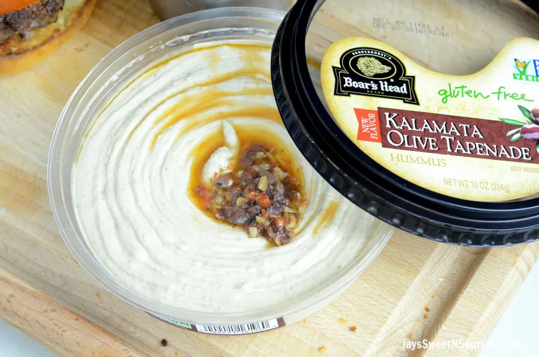 Boars Head Hummus Kalmata Olive Tapenade closeup. Deck the halls and your home with the smell of delicious fresh made Mediterranean Bison Burger and fries using Boar's Hummus as a spread.