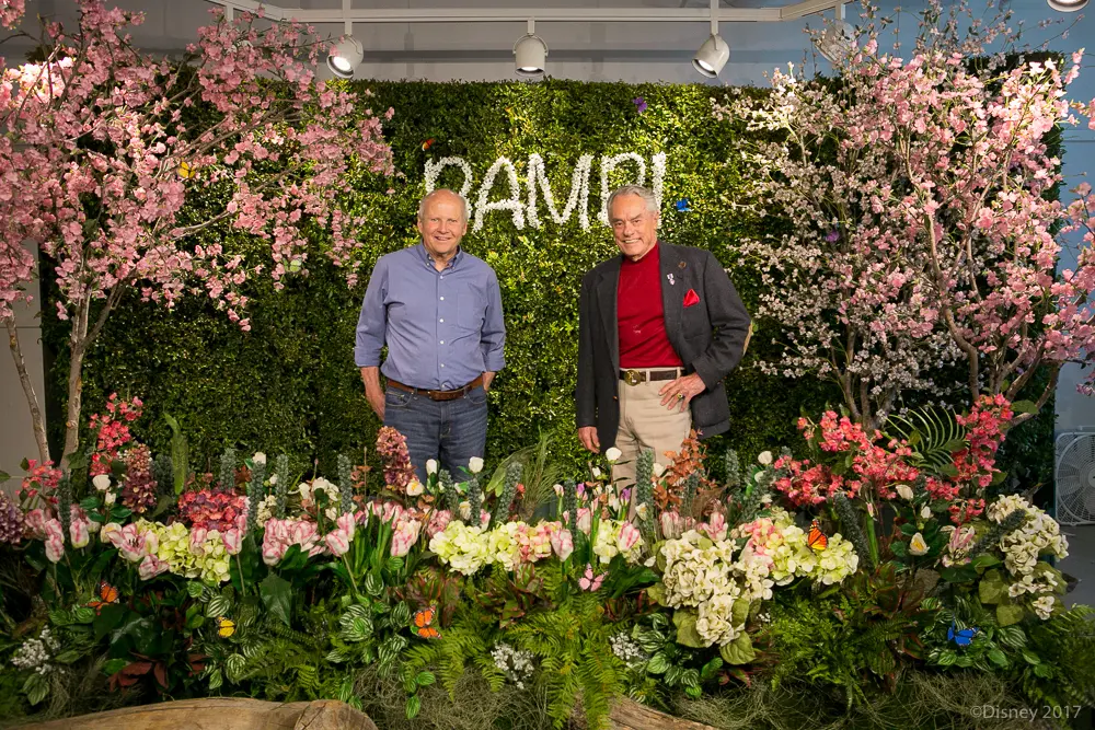 Peter Behn and Donnie Dunagan standing in group photo infront of Bambi themed backdrop during Interview With The Voices of Disney's Bambi and Thumper .