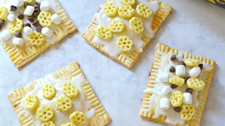 Homemade Honeycomb Cereal Pop-Tarts that are stuffed with apple butter and topped with homemade vanilla icing. Think Biggerer and be Back To School Ready with these easy homemade hand pies that you can stuff and top with your favorite flavors.
