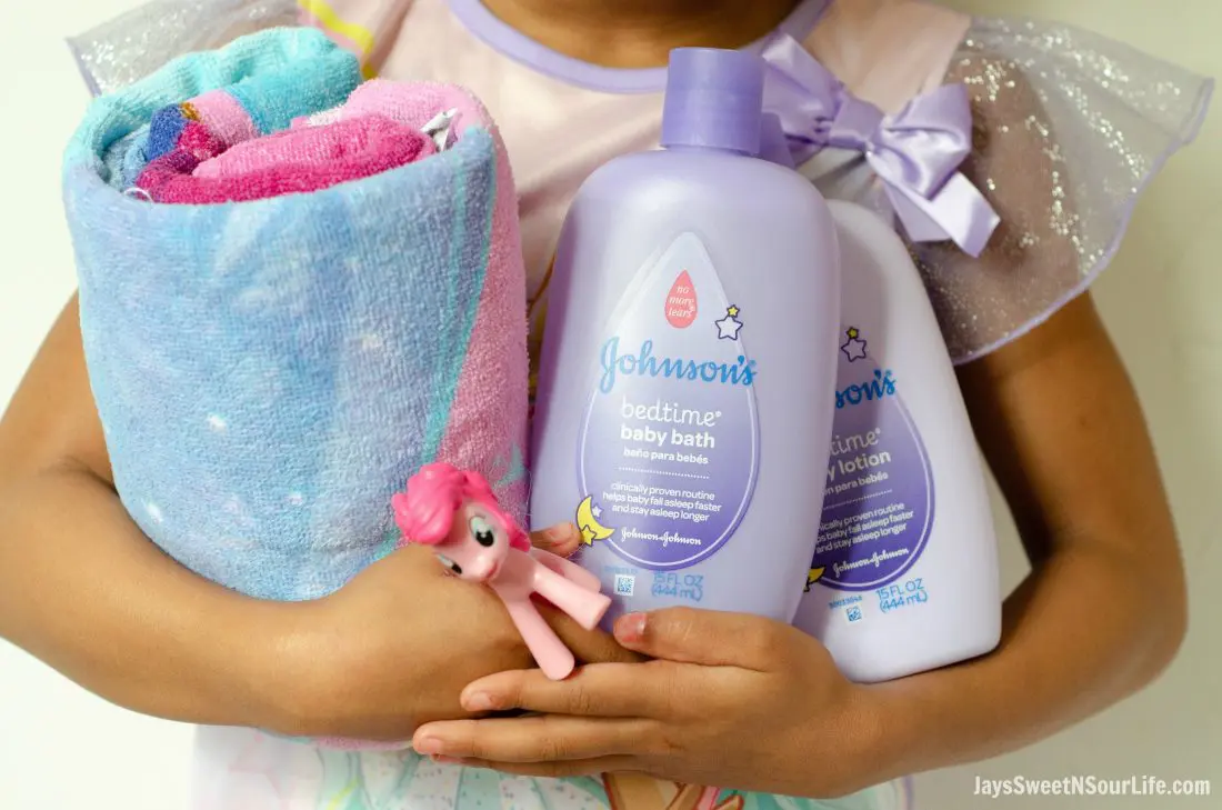 Create your very own Bathtime Travel kit with my checklist. Little african american girl holding her bathtime travel kit essentials.
