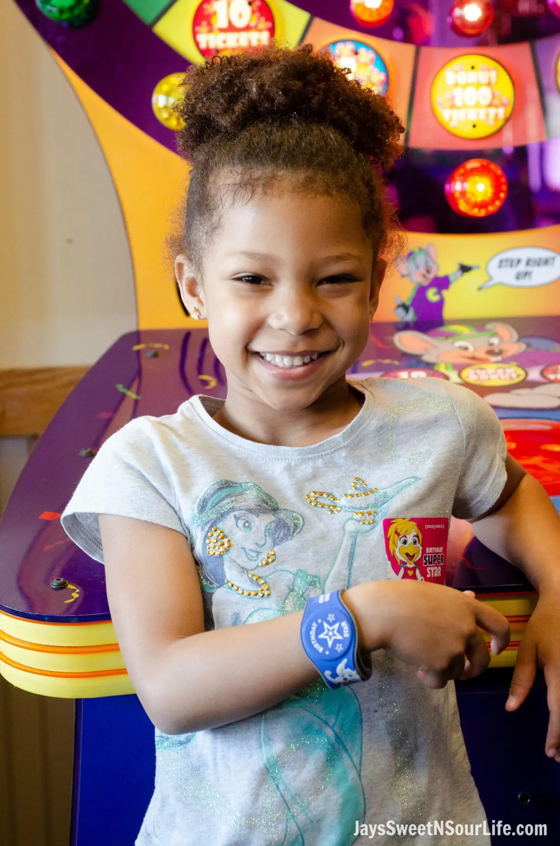 Chuck e cheeses VIP birthday Party with an African American birthday girl wearing a star wristband. Each Birthday Star Wristband gives the user 2 hours of unlimited play.