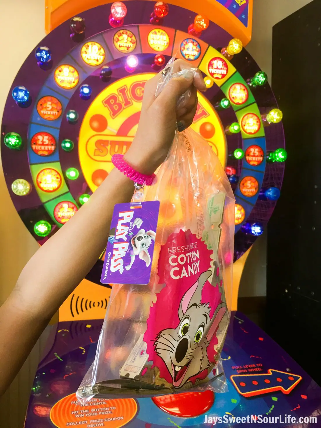 Chuck e cheeses VIP birthday Party Play Pass with wrist band, holding a bag of tickets. Book your party today and have guests enjoy 2 hours of unlimited game play.