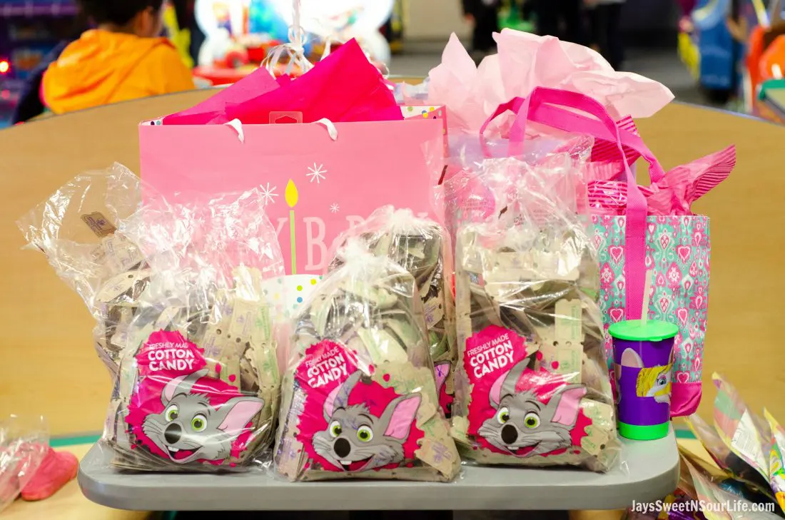 Chuck e cheeses VIP birthday Party Tickets and birthday gifts on table. Book your party today and have guests enjoy 2 hours of unlimited game play.