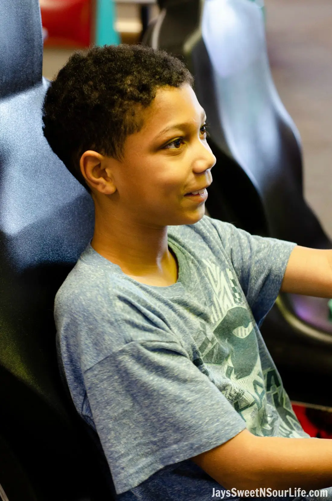 African american boy playing racing game at Chuck e cheeses VIP birthday party. Book your party today and have guests enjoy 2 hours of unlimited game play.