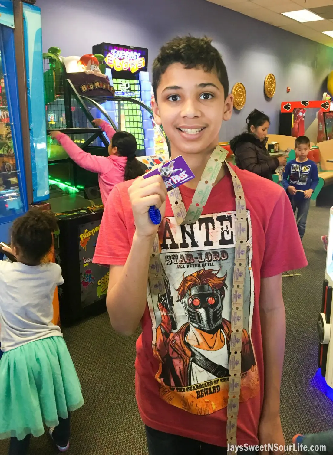 african american boy with tickets and play pass during Chuck e cheeses VIP birthday party. Book your party today and have guests enjoy 2 hours of unlimited game play.