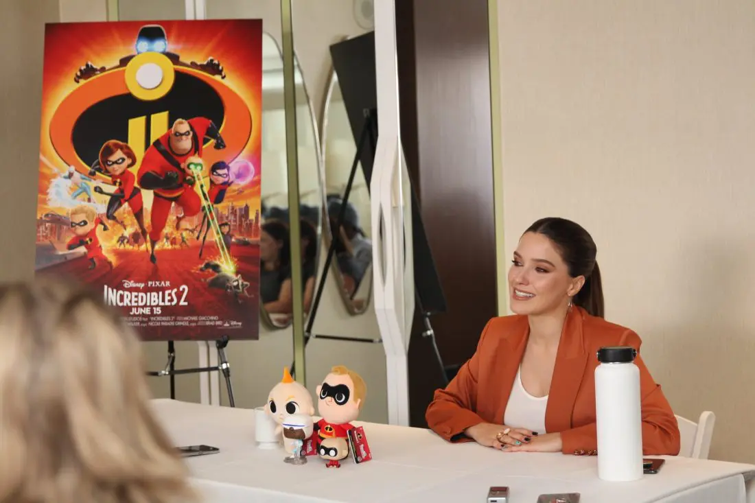 Incredibles 2 Interview with Sophia Bush Voice of Voyd Sitting next to Incredibles 2 Movie Poster. Disney Pixars Incredibles 2 film is in theaters everywhere today.