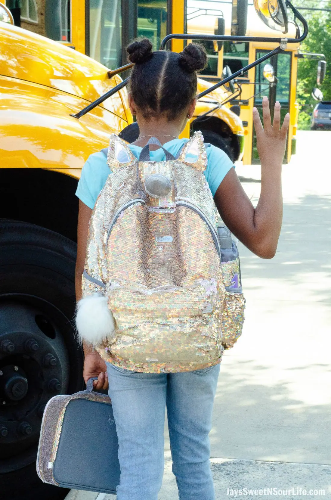 Justice Back To School Unicorn Backpack Lifestyle Shot Infront of Bus.Back To School Must Have Fashion For Tweens via JaysSweetNSourLife.com