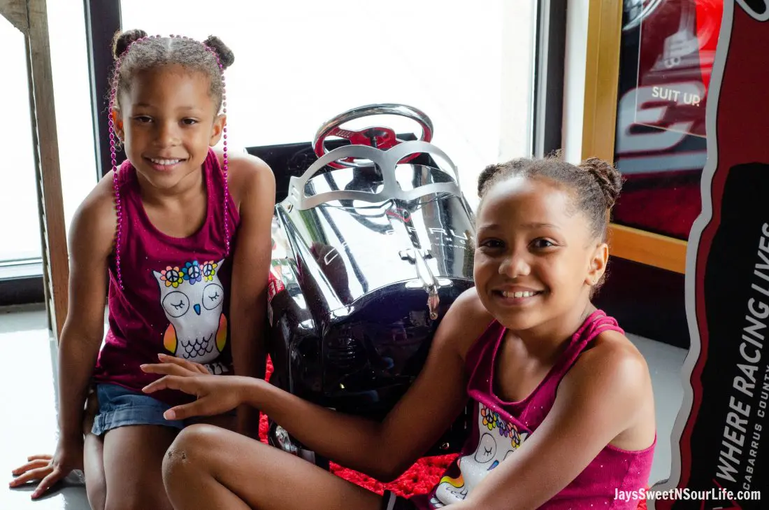 Visit Cabarrus County Vistor Center Girls Posing. A Large Families Adventure Guide To Cabarrus County - North Carolina - via JaysSweetNSourLife.com.