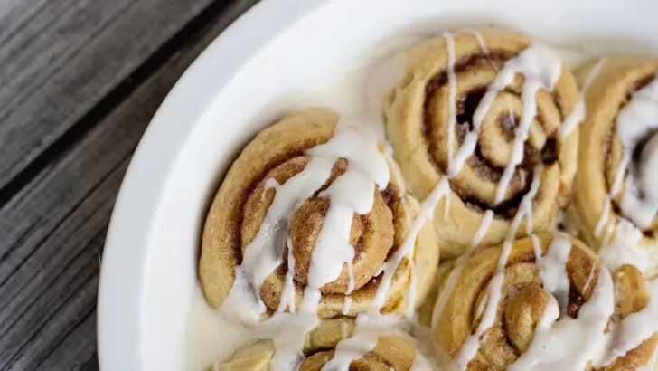 Pumpkin Spice Cinnamon Rolls Closeup Icing Drizzle. Fill your home with the delicious smell of these easy to make Pumpkin Spice Cinnamon Rolls.