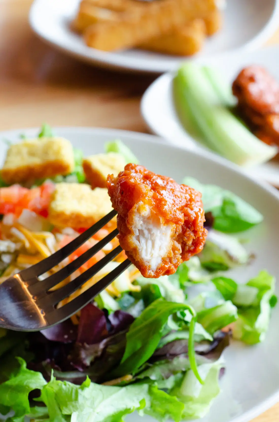 Buffalo Chicken on fork in front of Garden Salad at Applebee's. Take advantage of the Applebee&rsquo;s Delicious New Three-Course Meal&rsquo;s Starting at $12.