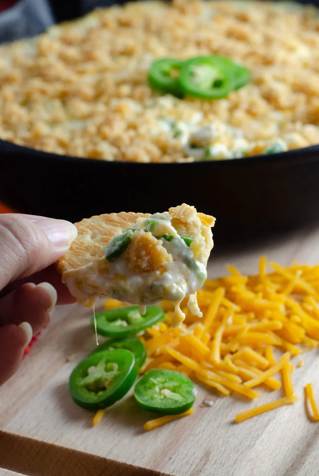 Jalape&ntilde;o Popper Dip on Cracker Closeup. Elevate your holiday entertaining with some wholesome, flavorful California cheeses in this easy to make Jalape&ntilde;o Popper Dip.