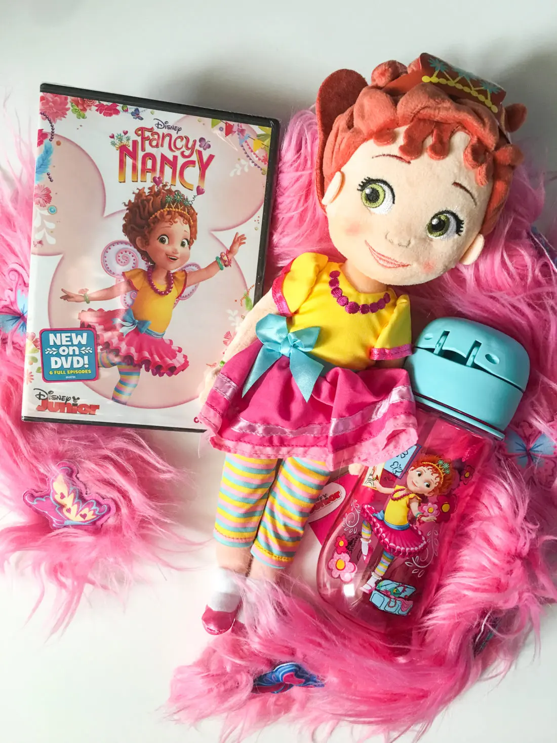 Fancy Nancy DVD Plush Toy and Canteen. Grab some glitter, add a dash of &ldquo;ooh la la,&rdquo; sprinkle in original songs and Voil&agrave;! Get set to pour on the fun with Fancy Nancy in her newest DVD from Disney Junior.