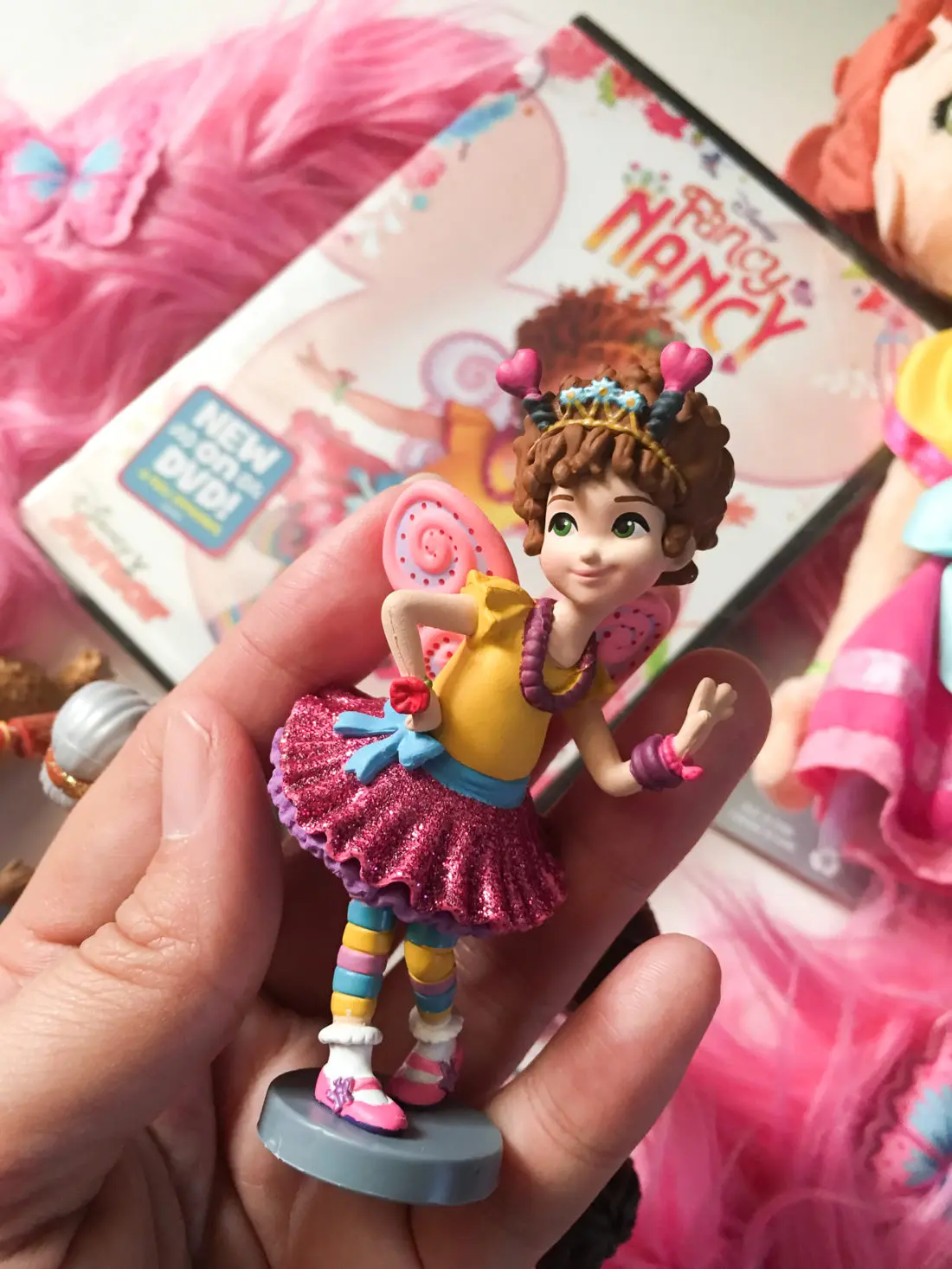 Fancy Nancy Figure Nancy. Grab some glitter, add a dash of &ldquo;ooh la la,&rdquo; sprinkle in original songs and Voil&agrave;! Get set to pour on the fun with Fancy Nancy in her newest DVD from Disney Junior.