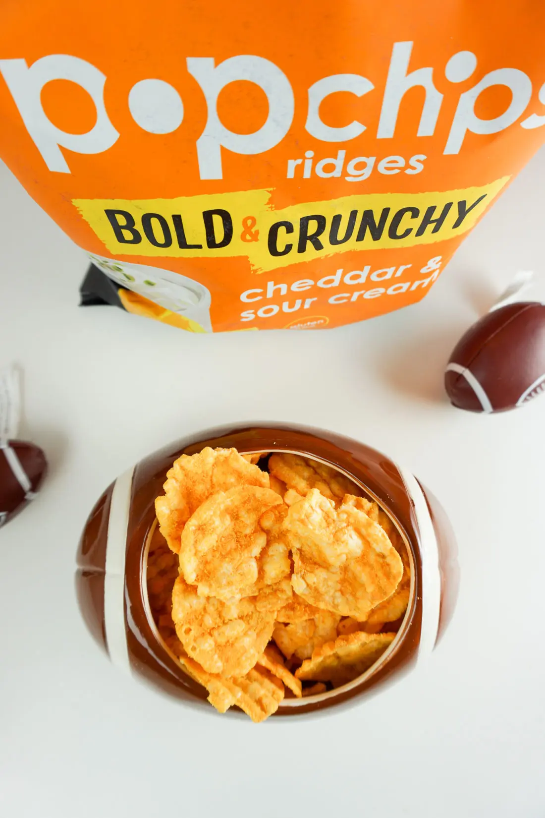 Popchips Cheddar and Sour Cream In Football Bowl. Stop stressing about what everyone will be eating on the Big Game Day. Take advantage of some awesome No-Cook Easy Game Day Snack Idea's on the blog now.