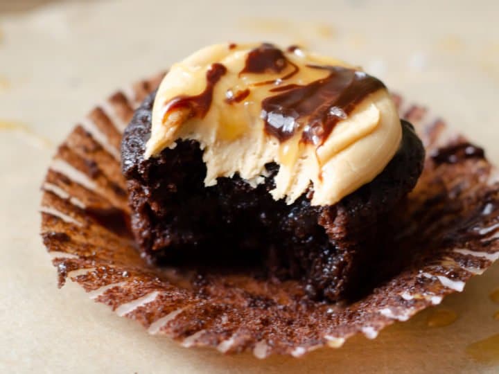 Super Moist Chocolate Cupcakes From Scratch Salted Caramel Frosting Bite Closeup. Celebrate any occasion with these decadent Super Moist Chocolate Cupcakes From Scratch with Salted Caramel Frosting and Caramel Filled Center. This homemade recipe is so easy to create, the kids can join in.