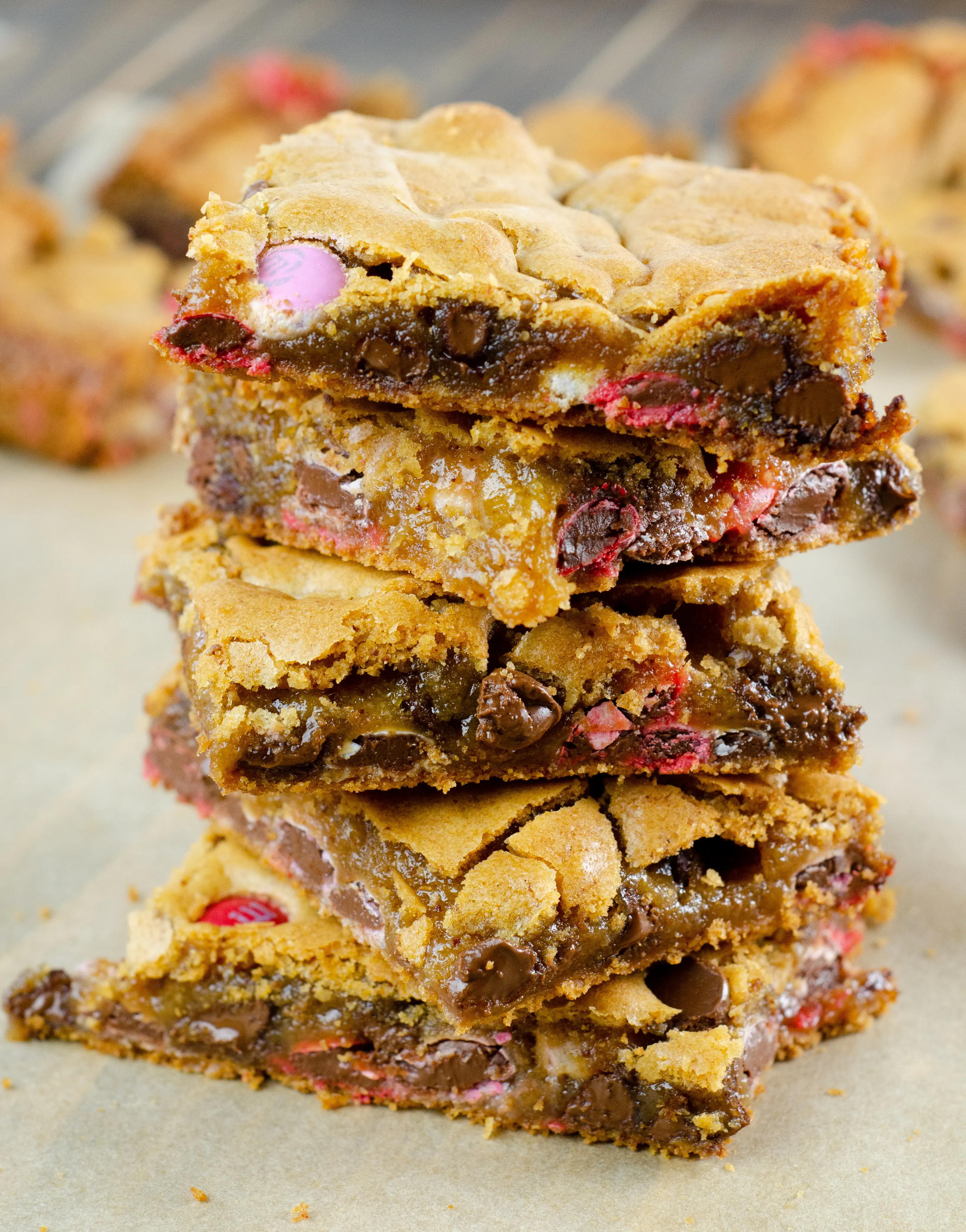 Brown Buttered M&M Blondies Bars Stacked. These Valentine's day themed Brown Buttered M&M Blondies are the perfect way to say I heart you to someone special. I love to bake them for my little ones year-round. They are so chewy and chocolatey they make it easy for me to look like a master dessert chef.