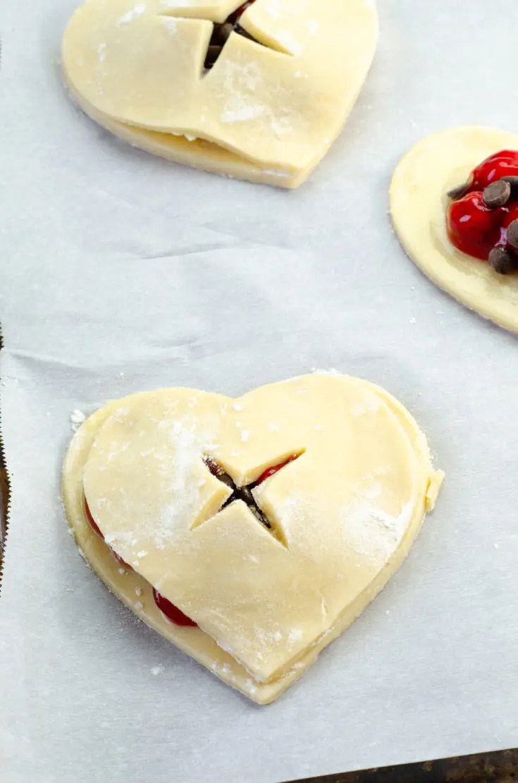 Chocolate Cherry Hand Pies Butter Pie Crust. Say I heart you to someone special this Valentine's Day with a delicious homemade treat. Try my super easy to make Chocolate Cherry Hand Pies which include a from scratch buttery flaky pie crust.