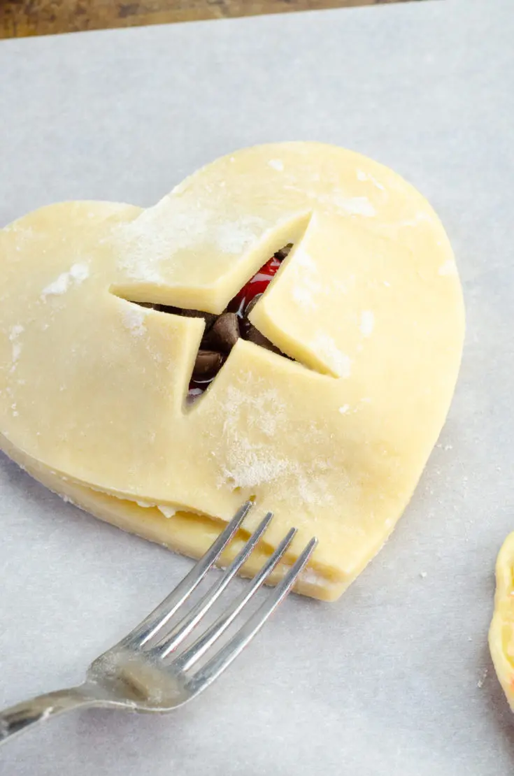 Chocolate Cherry Hand Pies Being Closed. Say I heart you to someone special this Valentine's Day with a delicious homemade treat. Try my super easy to make Chocolate Cherry Hand Pies which include a from scratch buttery flaky pie crust.