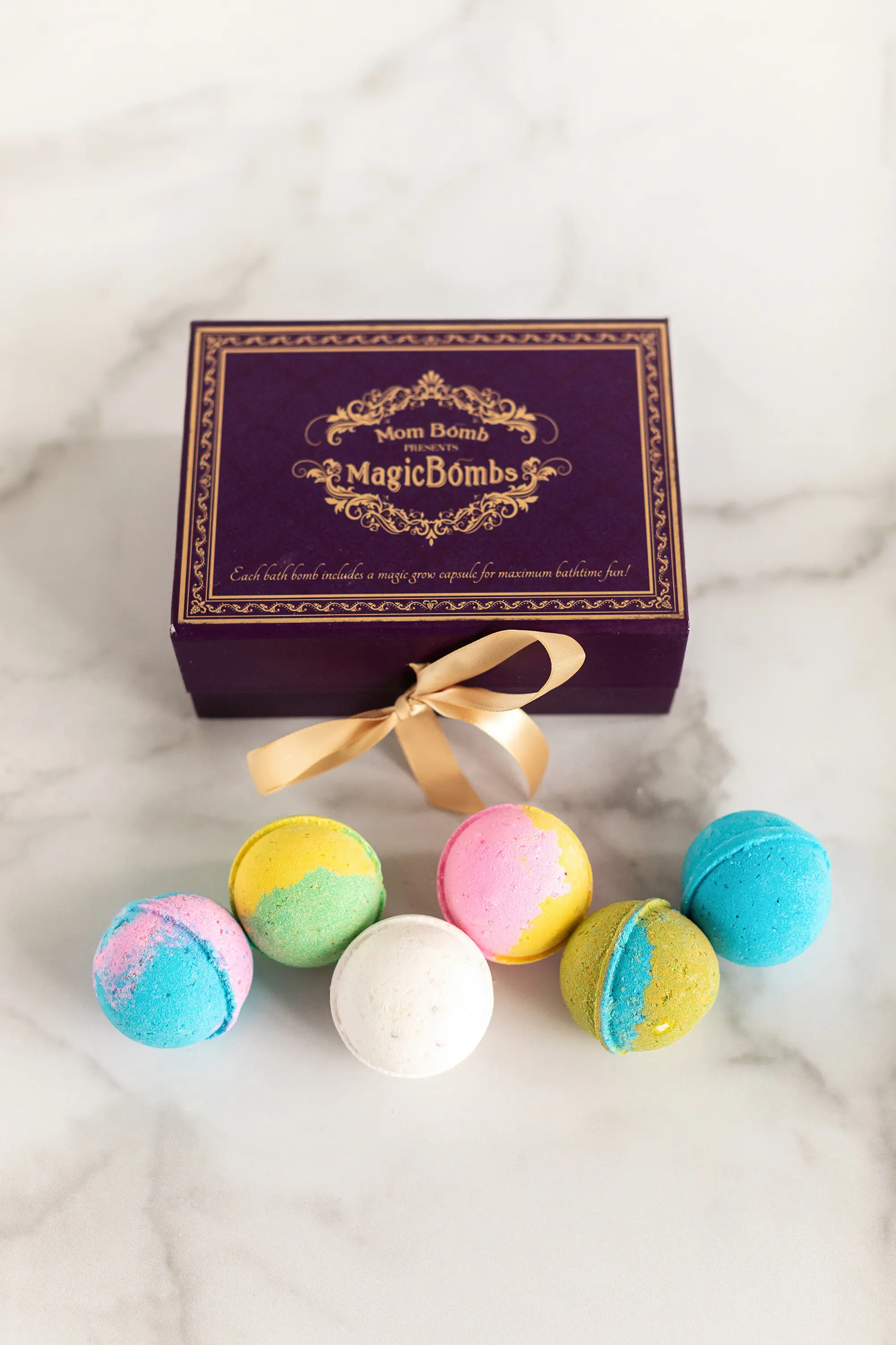 MomBomb Magic Box. Six unique fun-scented, vibrant colored bath bombs are nestled in a beautiful keepsake box, tied with satin ribbon. Each gift set comes with 6 unique scents that are the perfect balance without overwhelming the senses. 2020 Valentine's Day Gift Guide from Jays Sweet N Sour Life Blog.