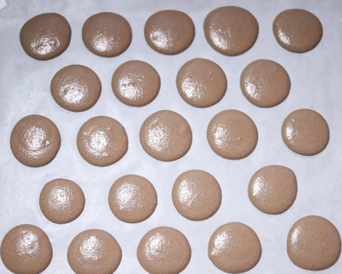 Chocolate Macarons with Salted Caramel Filling in pan. These Chocolate Macarons with Salted Caramel Filling are a delight, so soft and full of flavor. Perfect for entertaining as well as sweet treat gifts to loved ones during the holidays.&nbsp;
