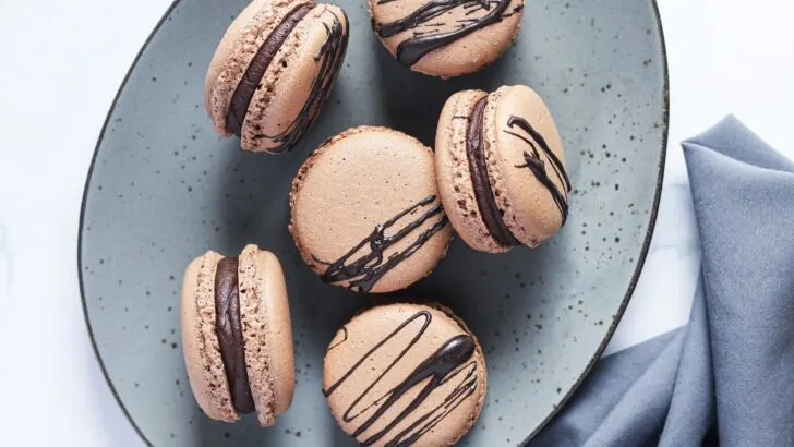 Chocolate Macarons with Salted Caramel Filling Plated.These Chocolate Macarons with Salted Caramel Filling are a delight, so soft and full of flavor. Perfect for entertaining as well as sweet treat gifts to loved ones during the holidays. 