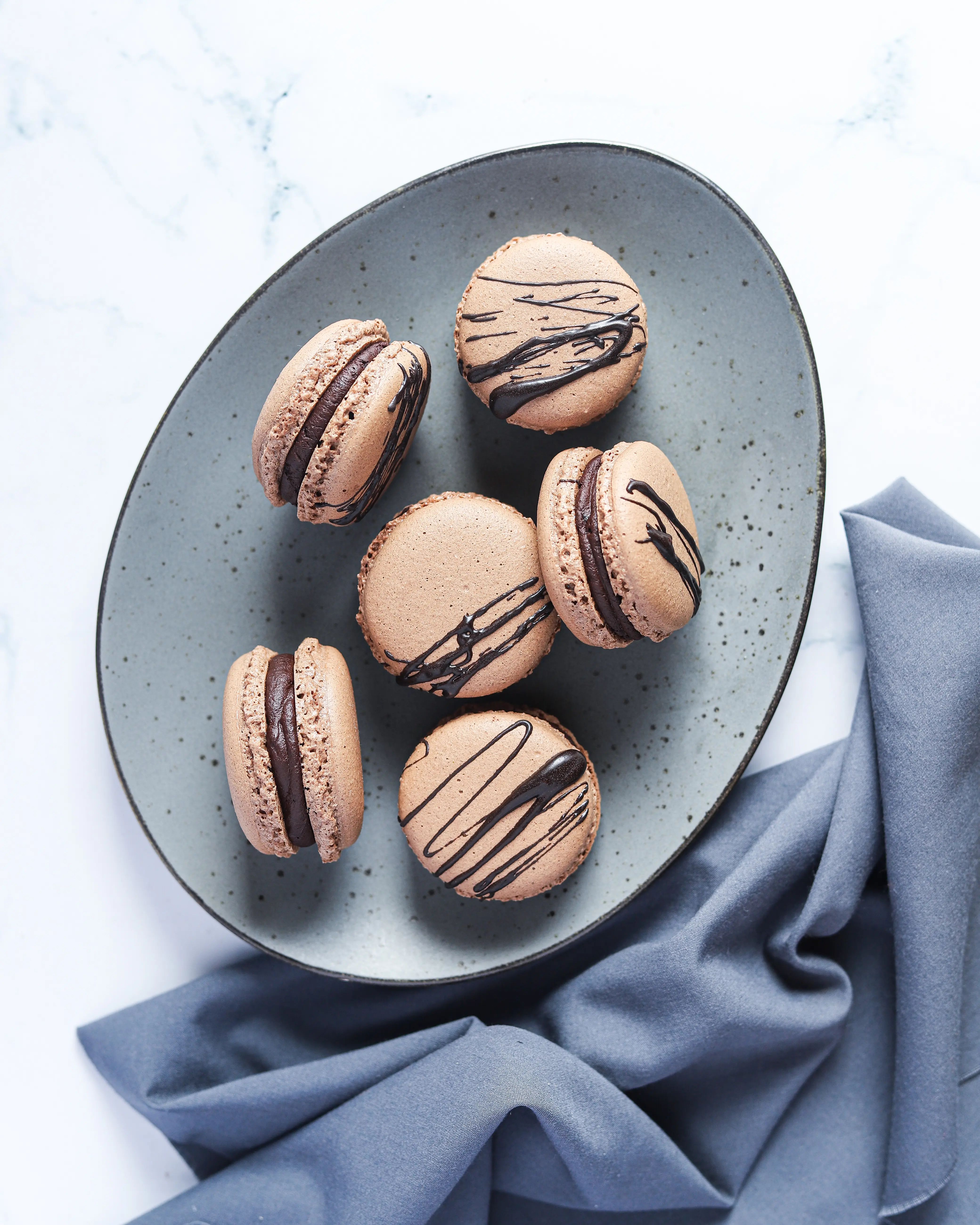 Chocolate Macarons with Salted Caramel Filling Plated.These Chocolate Macarons with Salted Caramel Filling are a delight, so soft and full of flavor. Perfect for entertaining as well as sweet treat gifts to loved ones during the holidays.&nbsp;