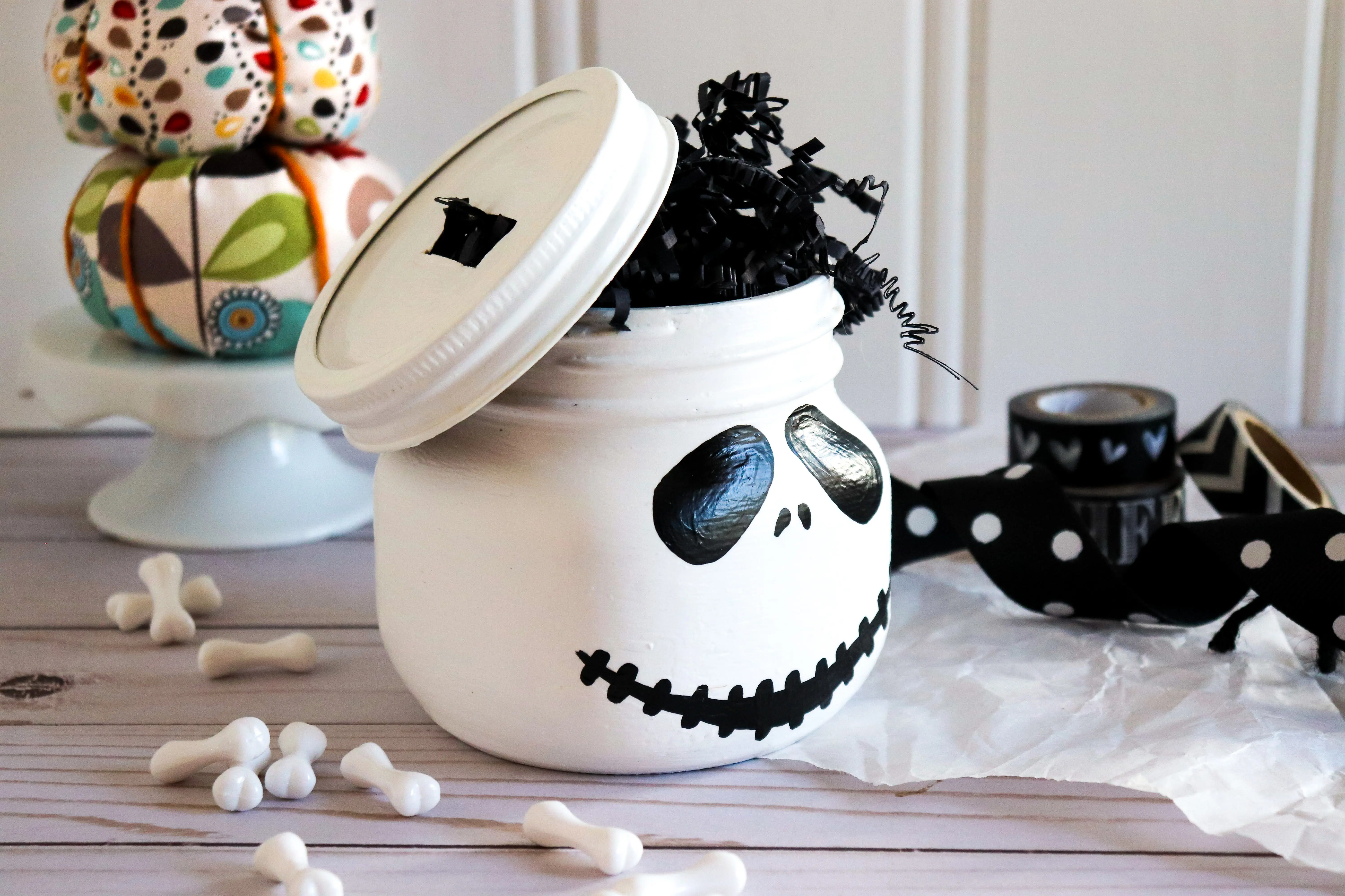 Jack Skellington Mason Jar Side View. This Jack Skellington Mason Jar Halloween Craft is the perfect way to creep your way into the Halloween season. Fill it with your favorite candies and treats, it's the perfect Halloween Craft that you can keep or gift.