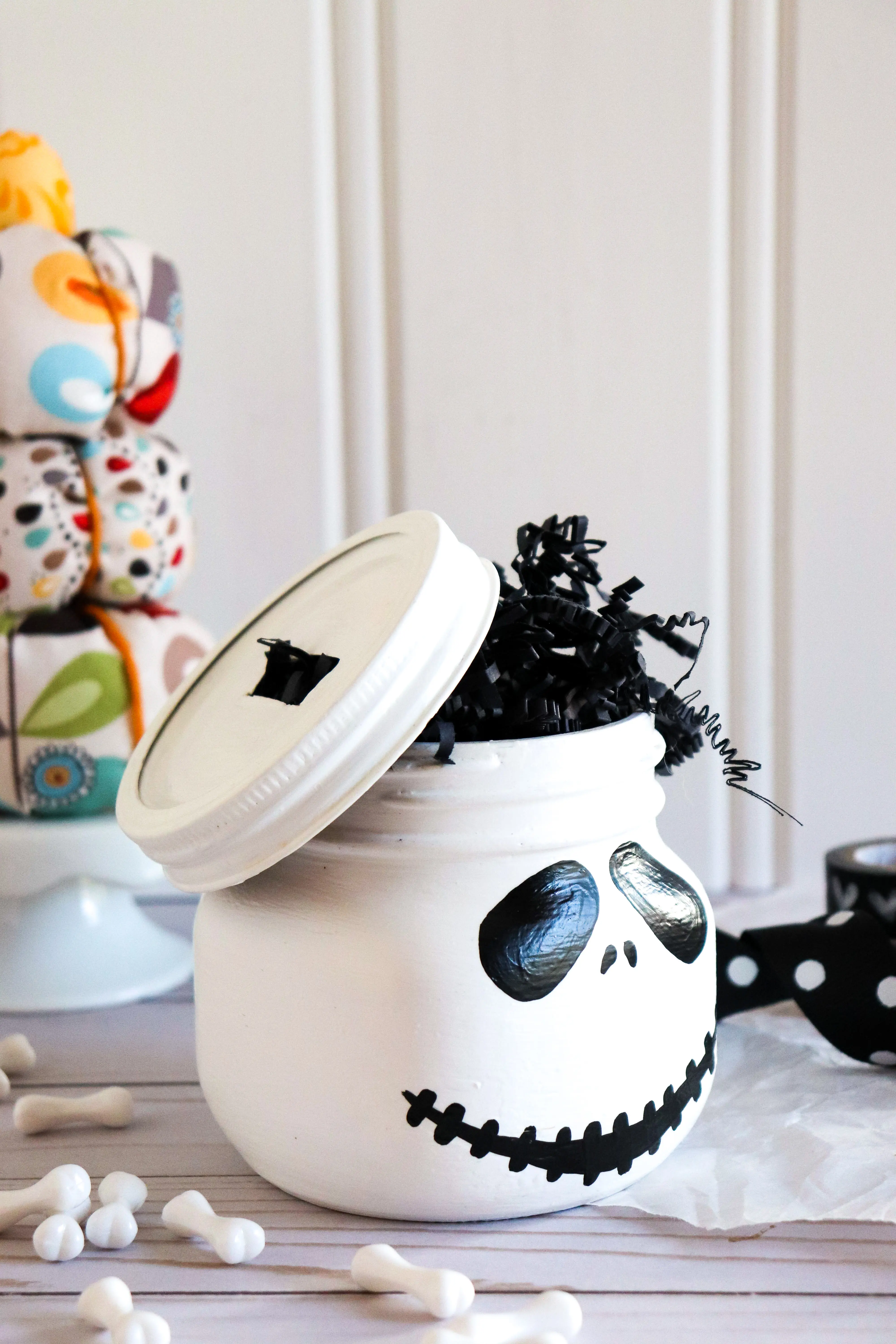 Jack Skellington Mason Jar Side View Closeup. This Jack Skellington Mason Jar Halloween Craft is the perfect way to creep your way into the Halloween season. Fill it with your favorite candies and treats, it's the perfect Halloween Craft that you can keep or gift.