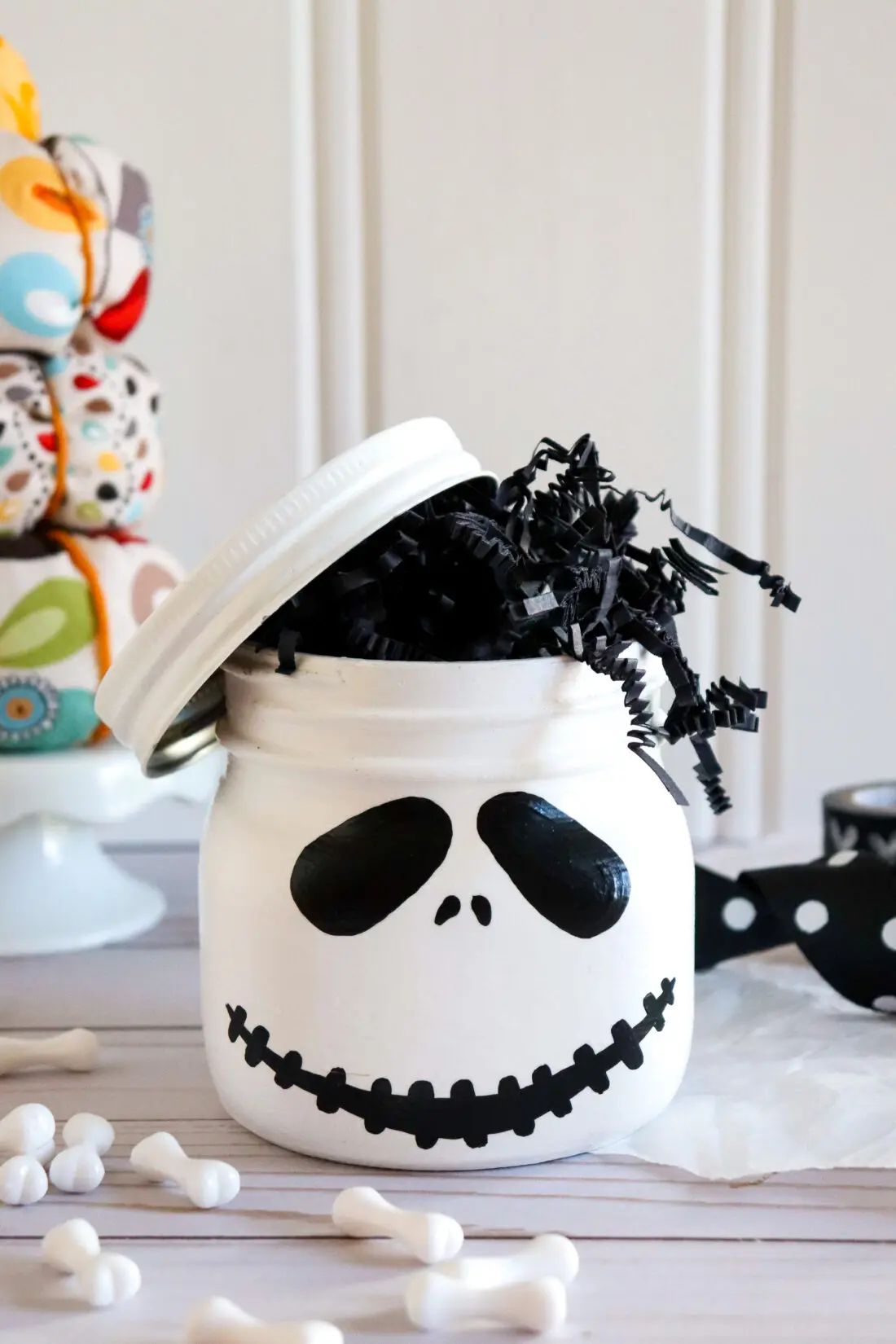 Jack Skellington Mason Jar Closeup. This Jack Skellington Mason Jar Halloween Craft is the perfect way to creep your way into the Halloween season. Fill it with your favorite candies and treats, it's the perfect Halloween Craft that you can keep or gift.