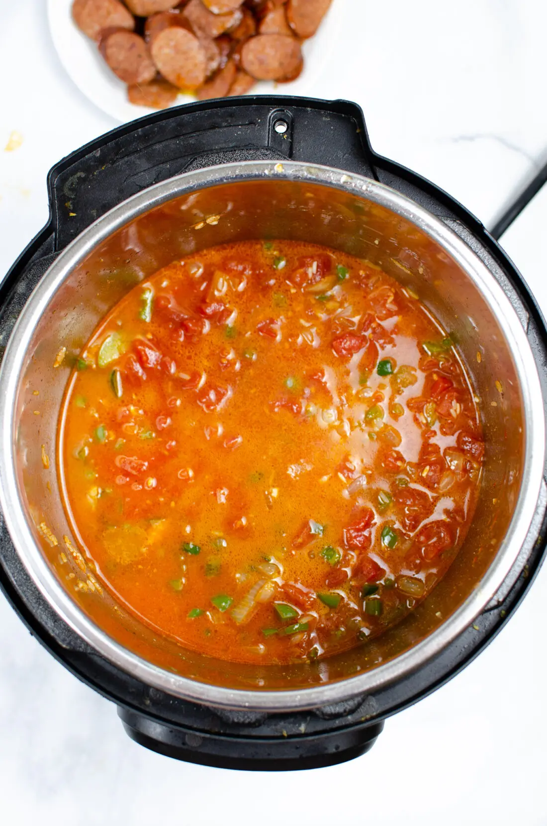 An authentic Instant Pot Andouille Sausage Jambalaya recipe that can be made in 30 minutes! This flavorful easy one-pan jambalaya recipe is made with andouille sausage, bell peppers, onion, celery, and spices. It's an instant family favorite recipe that is perfect for busy nights.