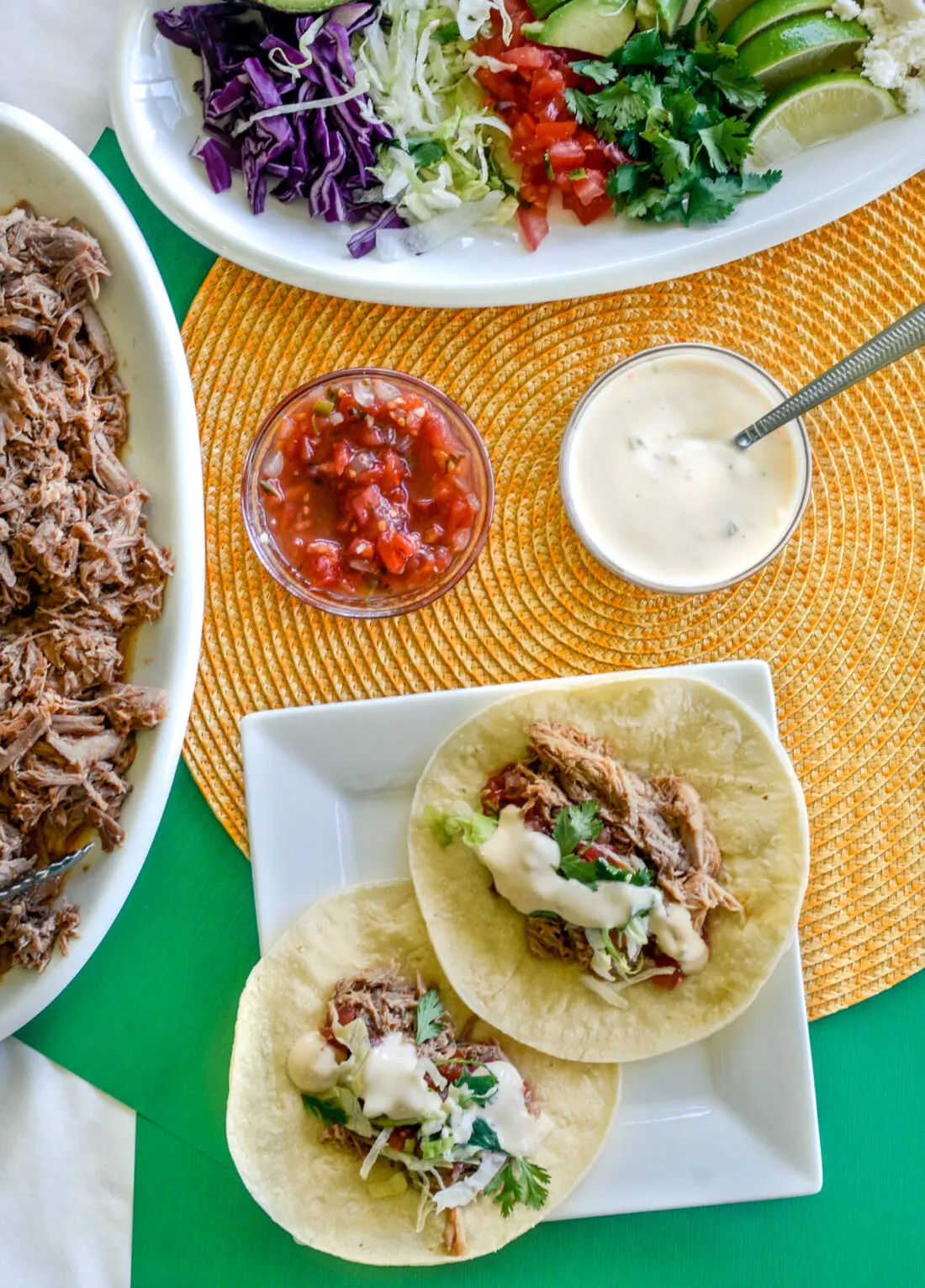 Pulled Pork Tacos Tablespread. These Easy Pulled Pork Tacos have juicy flavorful pulled pork that's cooked low and slow. Piled high with your favorite toppings, make these ahead of time for large crowds and gatherings. Any day is a Taco Tuesday!