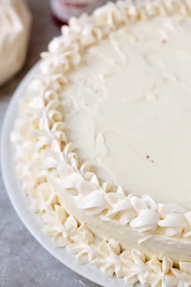 Red Velvet Cheesecake Topped with Icing. This beautiful 2 layered Red Velvet Cheesecake is made with a moist red velvet cake and a smooth, creamy cheesecake layer on the top. It's as if a cake and cheesecake had a baby, both layers made with love and topped with a cream cheese frosting.