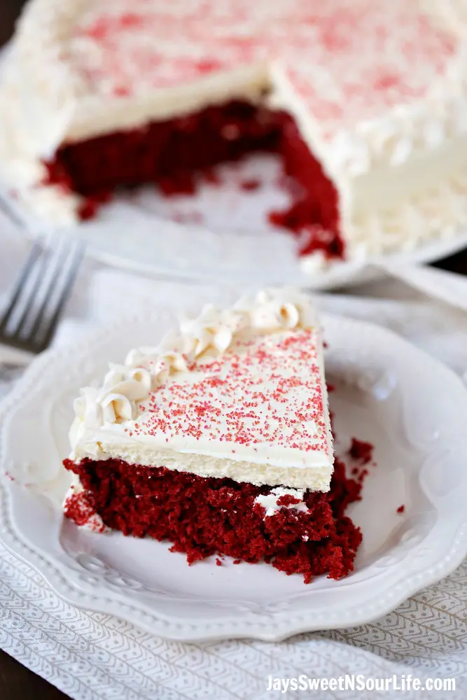 This beautiful 2 layered Red Velvet Cheesecake is made with a moist red velvet cake and a smooth, creamy cheesecake layer on the top. It's as if a cake and cheesecake had a baby, both layers made with love and topped with a cream cheese frosting.