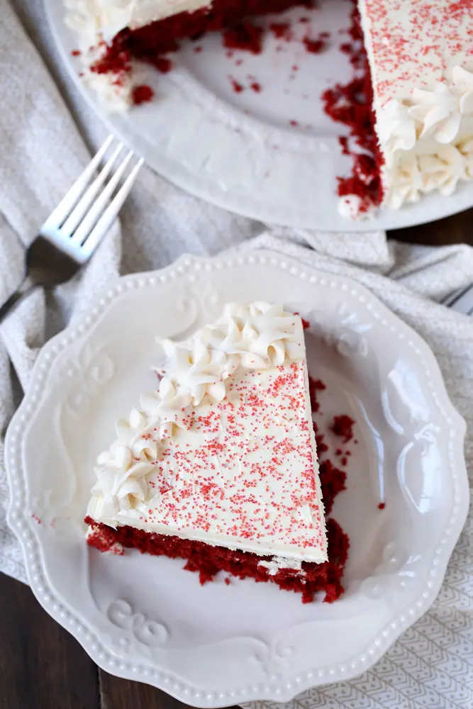 Red Velvet Cheesecake Overhead. This beautiful 2 layered Red Velvet Cheesecake is made with a moist red velvet cake and a smooth, creamy cheesecake layer on the top. It's as if a cake and cheesecake had a baby, both layers made with love and topped with a cream cheese frosting.