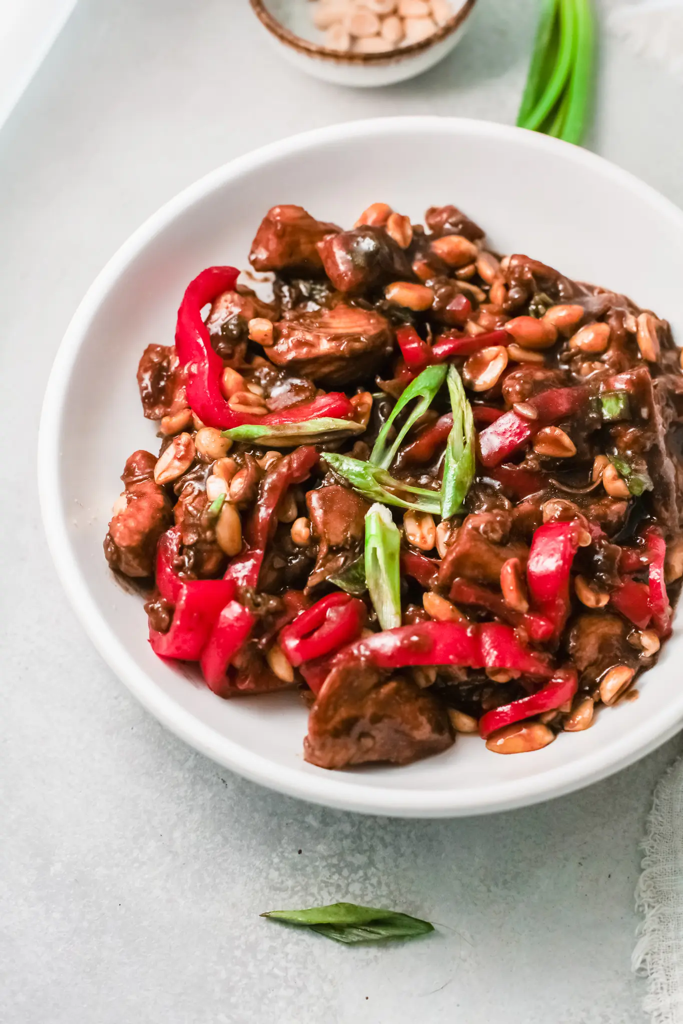 Better than Chinese takeout, make this Kung Pao Chicken at home. Up-close shot of the Kung Pao Chicken dish showcasing the fresh vegetables used in this dish along with the chicken in a savory sauce.